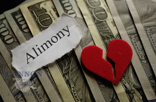 Alimony and broken heart on top of money. Alimony concept.