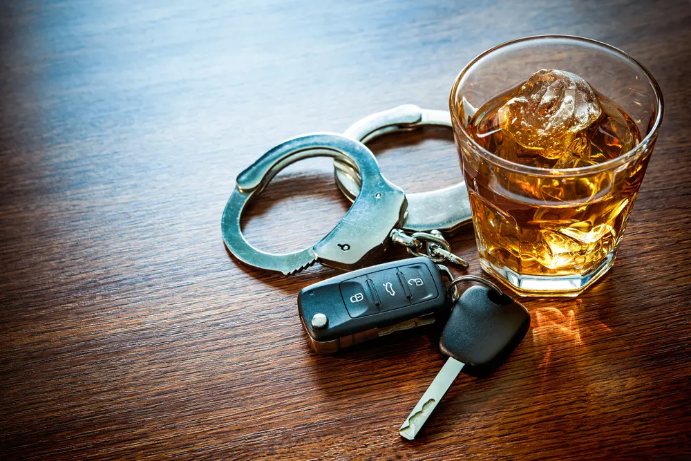 Glass of beer, keys, and handcuffs.