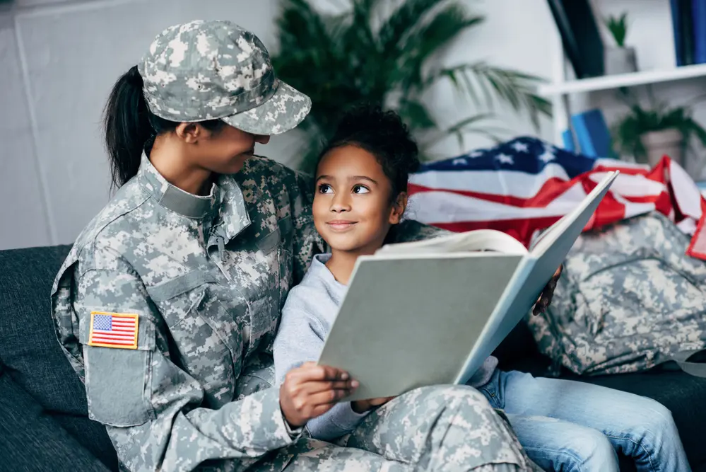 A military woman reading to her child.