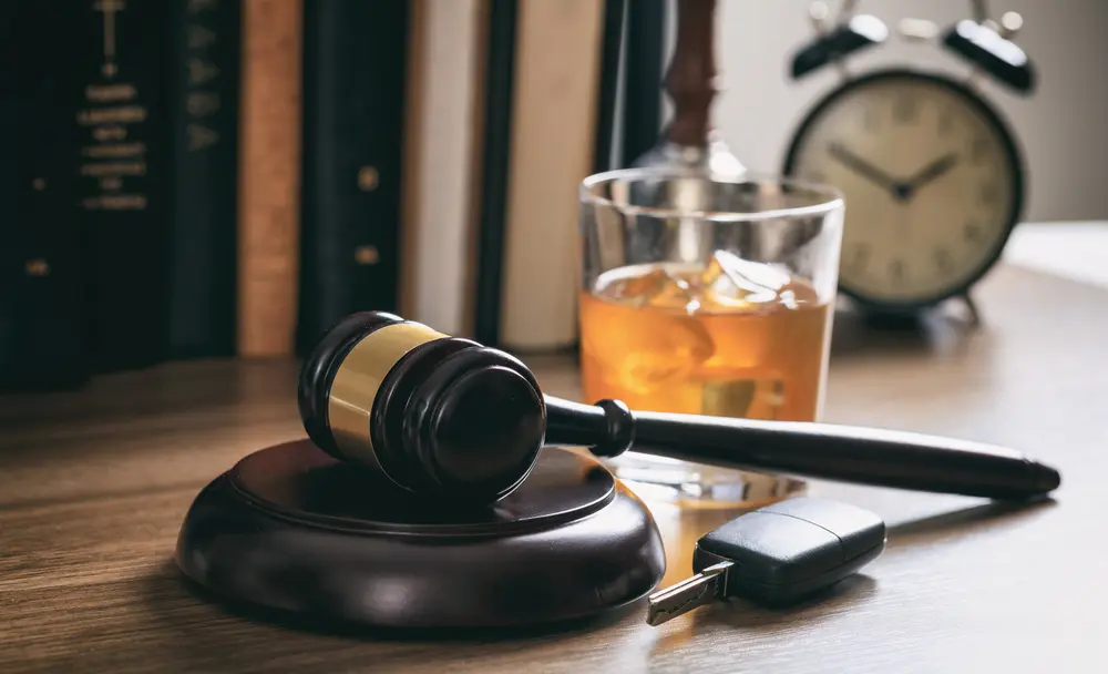 A gavel, keys, and a glass of beer.