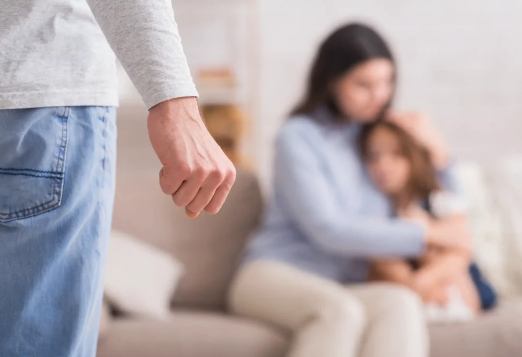 Man holding his fist up to scared mother and daughter. If you've endured violence in your marriage, our Oklahoma City lawyers can help you file for divorce. 