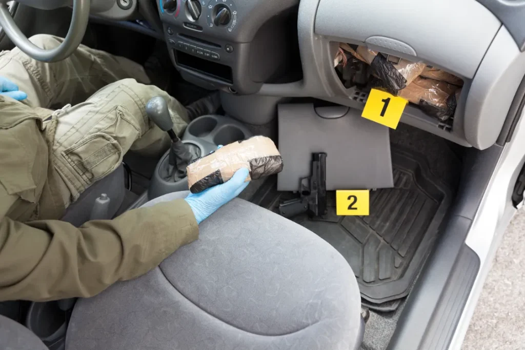 Officer finding drugs hidden in car. Crime scene.