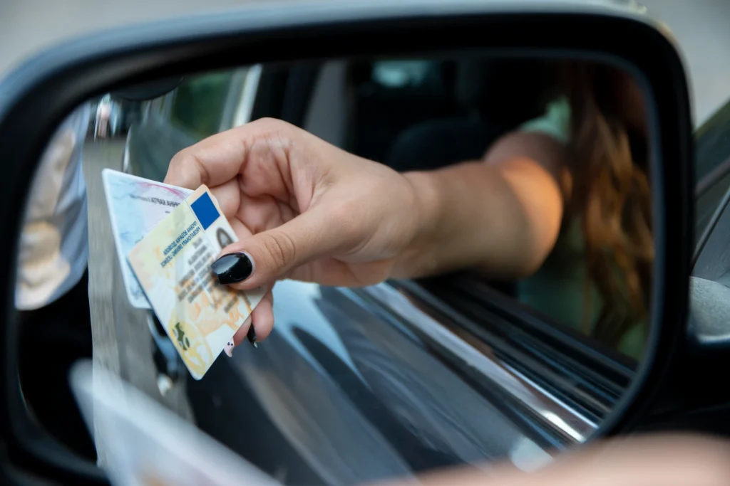 a woman handing her license out