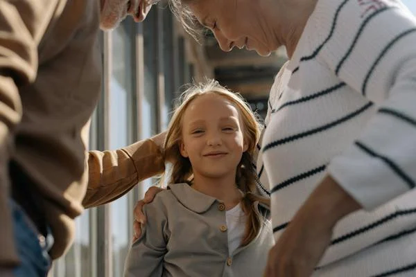 girl smiling with grandparents