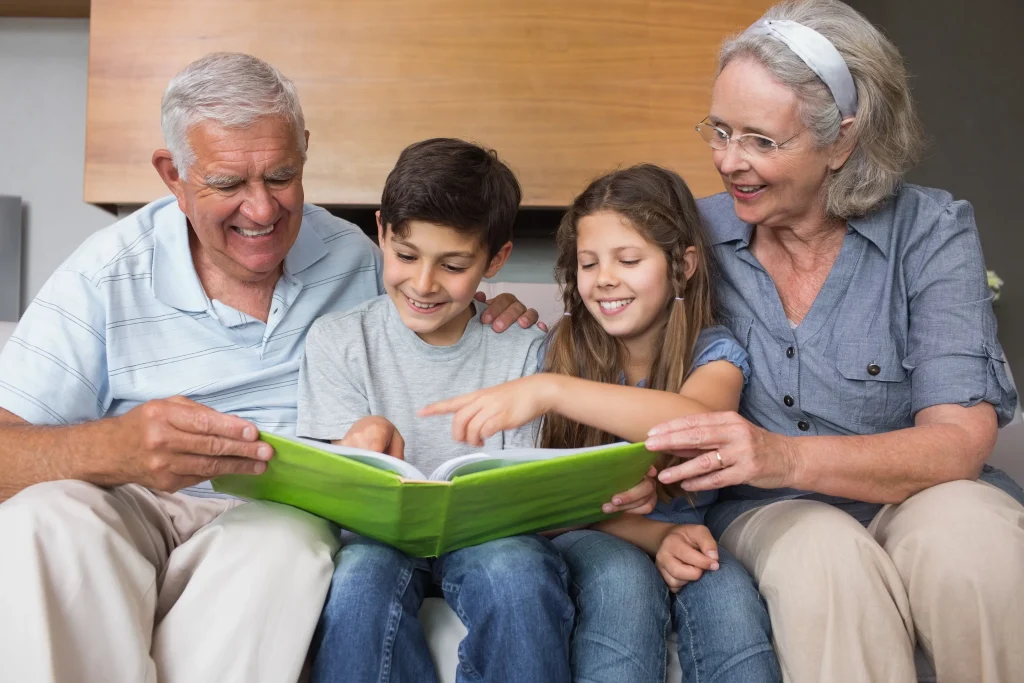 Elderly grandparents reading to their grandchildren.