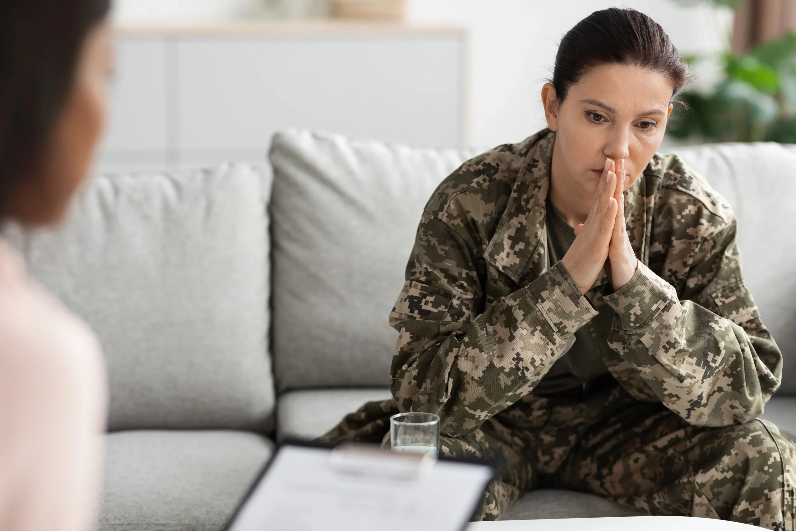 Military woman discussing her divorce with a therapist.