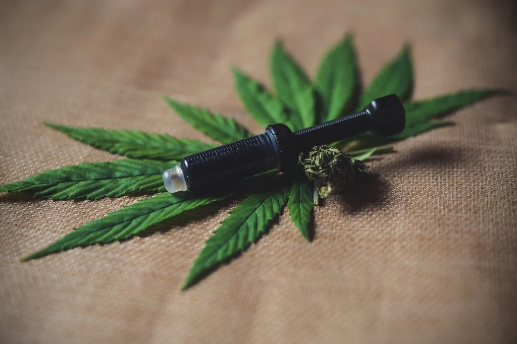 Medical marijuana extract sitting on top of a marijuana leaf.