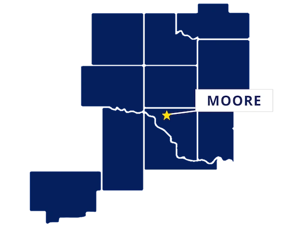 Map highlighting Moore, Oklahoma with a yellow star and label, surrounded by outlined counties in dark blue.