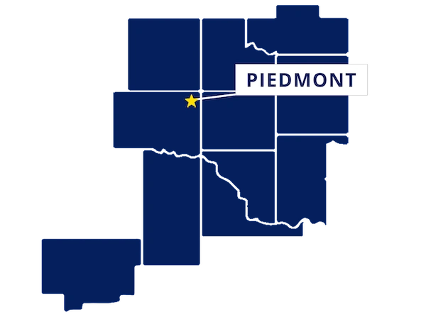 Map highlighting Piedmont, Oklahoma with a yellow star and label, surrounded by outlined counties in dark blue.