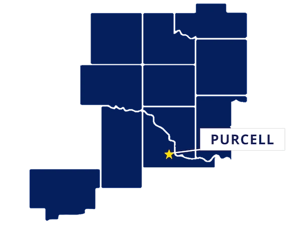Map highlighting Purcell, Oklahoma with a yellow star and label, surrounded by outlined counties in dark blue.