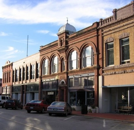 Old storefront with car in front in downtown Guthrie Oklahoma