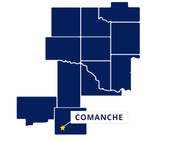 Map highlighting Comanche, Oklahoma with a yellow star and label, surrounded by outlined counties in dark blue.